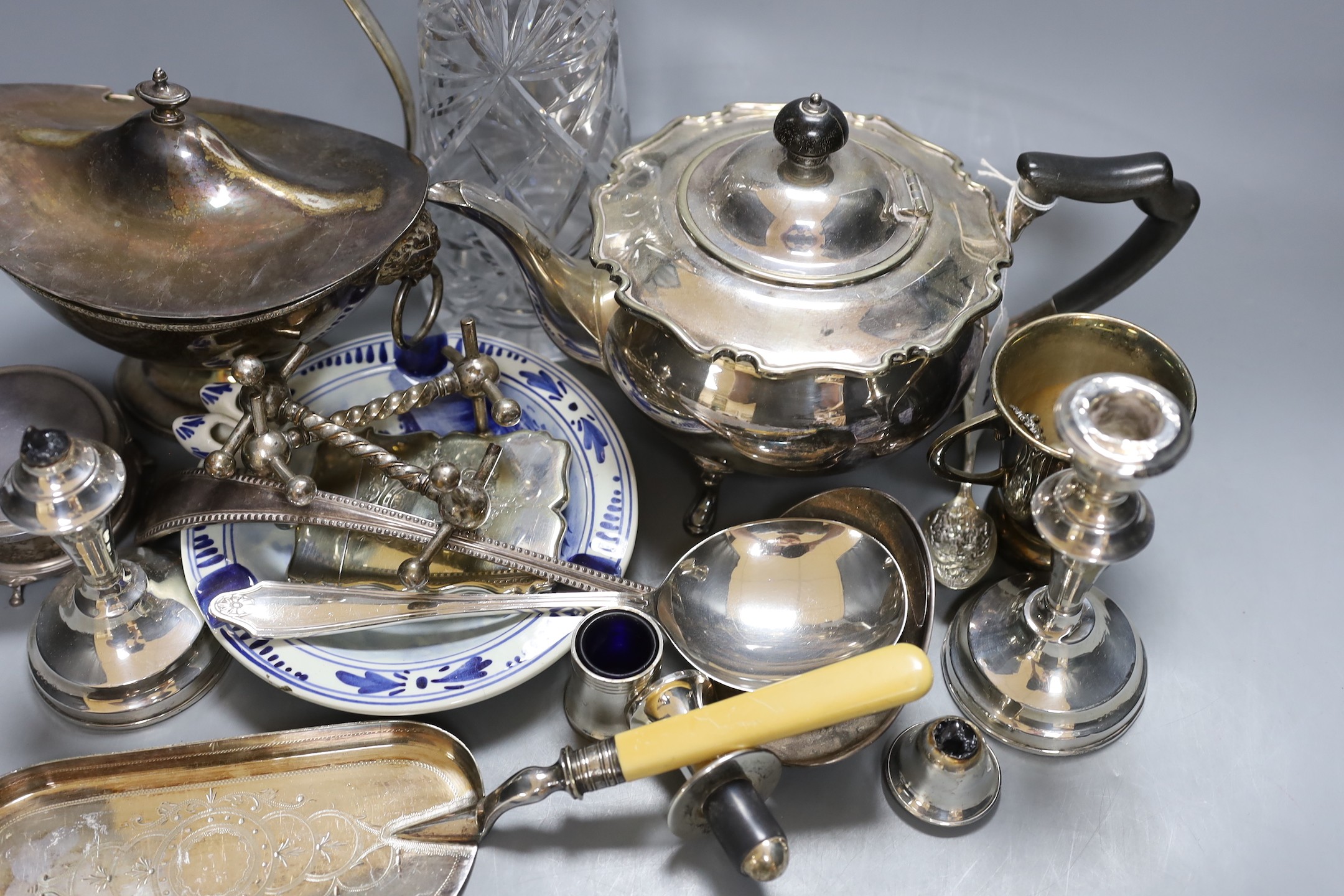 Assorted plated ware including a claret jug, teapot, sauce tureen, a pair of silver mounted dwarf candlesticks(a.f.) etc.